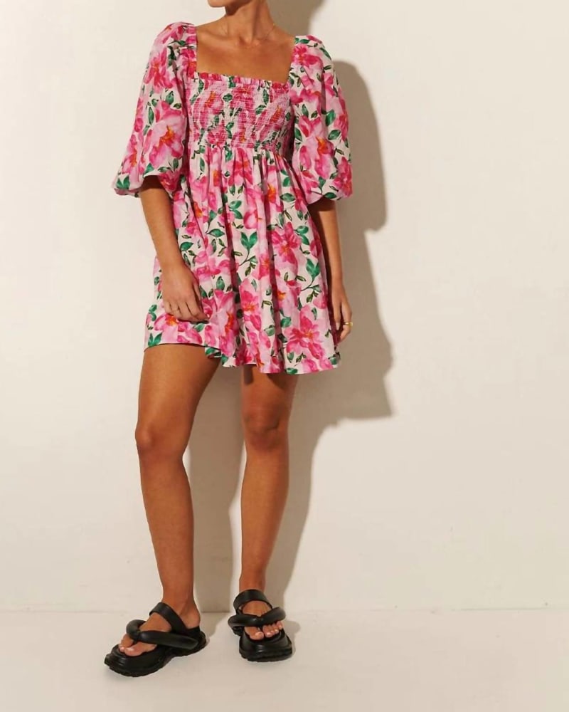 Side of a model wearing a size L/12 Antonia Shirred Mini Dress in Pink in Pink by KIVARI. | dia_product_style_image_id:339063